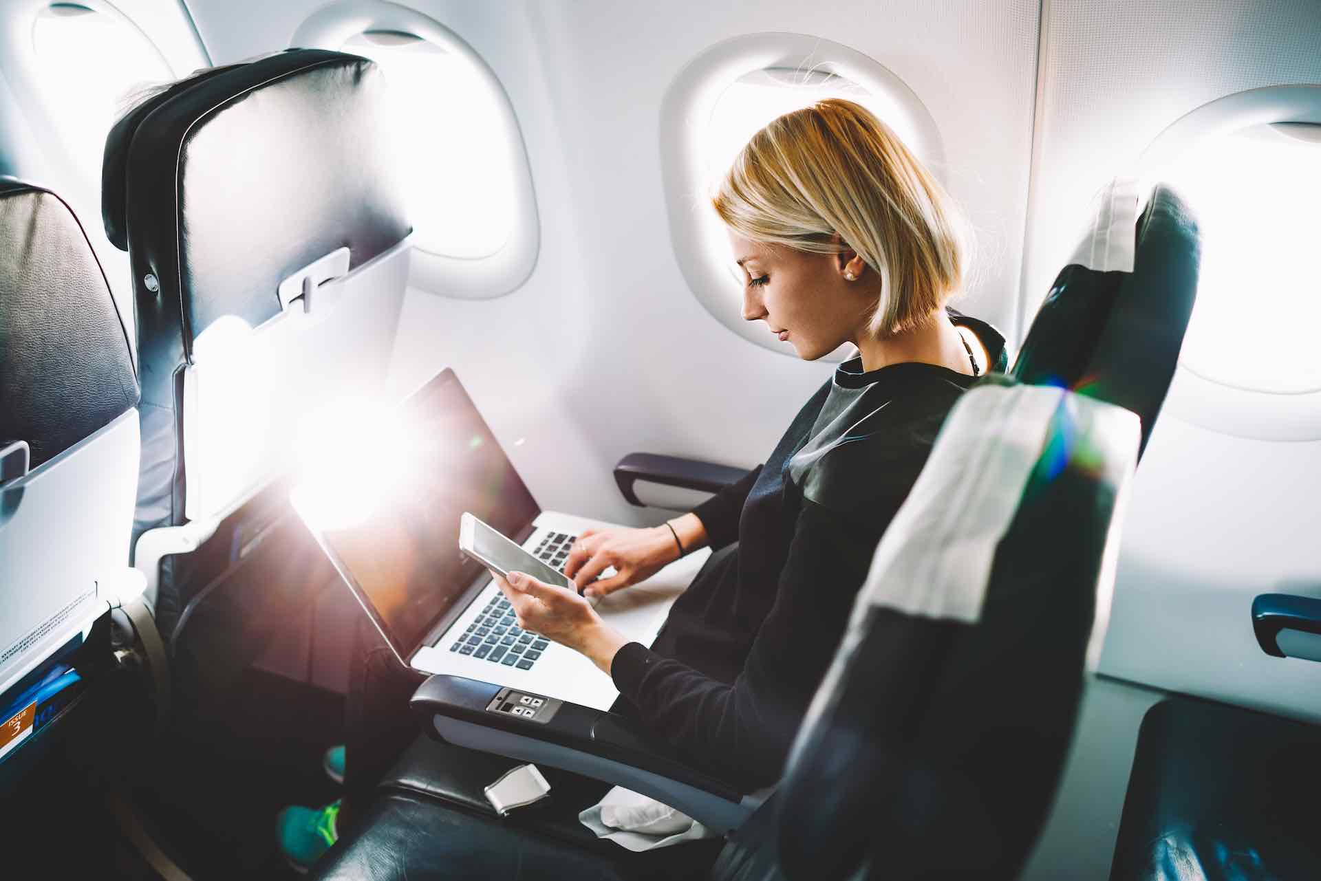 mulher usando celular com 5G a bordo de um avião