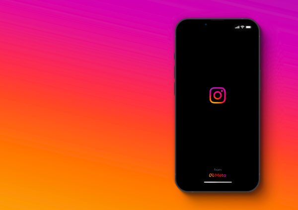 Imagem mostra o logotipo do Instagram em exibição em uma tela de smartphone, com fundo colorido